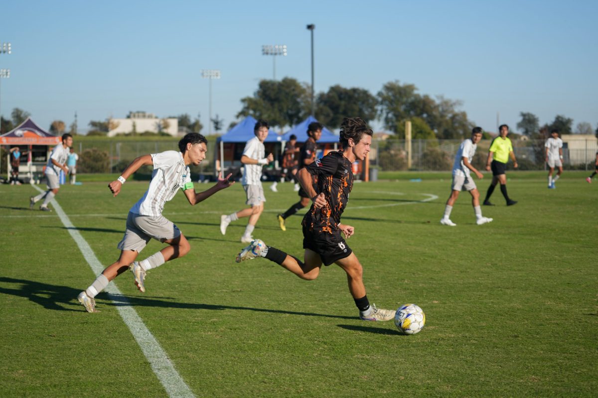 The Hawks’ sophomore forward, Mason Harder, advances the ball up field against a Clovis Community College midfielder at home on Tuesday. The Hawks defeat Clovis 4-0 before losing to the Fresno City College Rams on Friday at home 2-0.