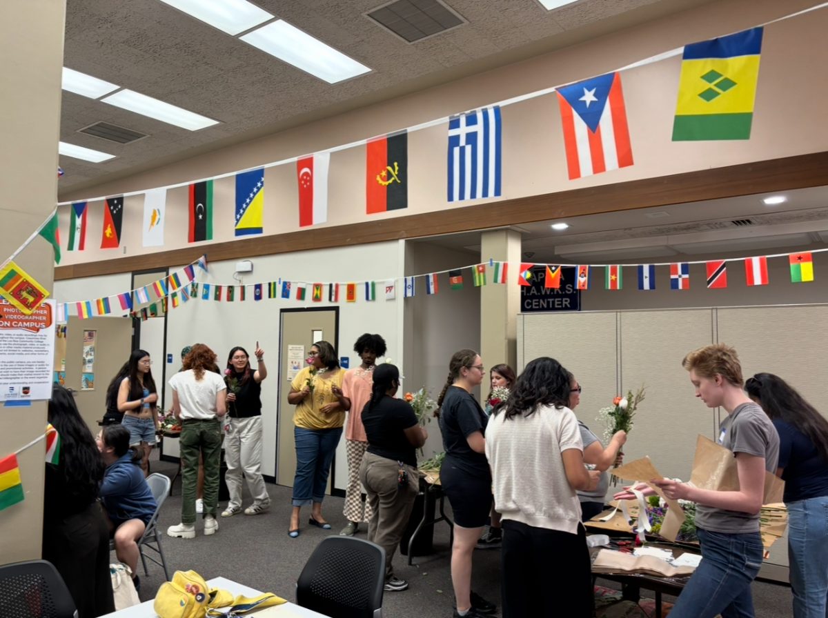 Students form a buffet style line with flowers and decorations to participate in a bouquet-making event inside of the Center for Inclusion and Belonging, held by the Pride Center in the library on the first floor on Oct. 1. The Pride Center is hosting multiple events throughout October for LGBTQ+ History Month.
