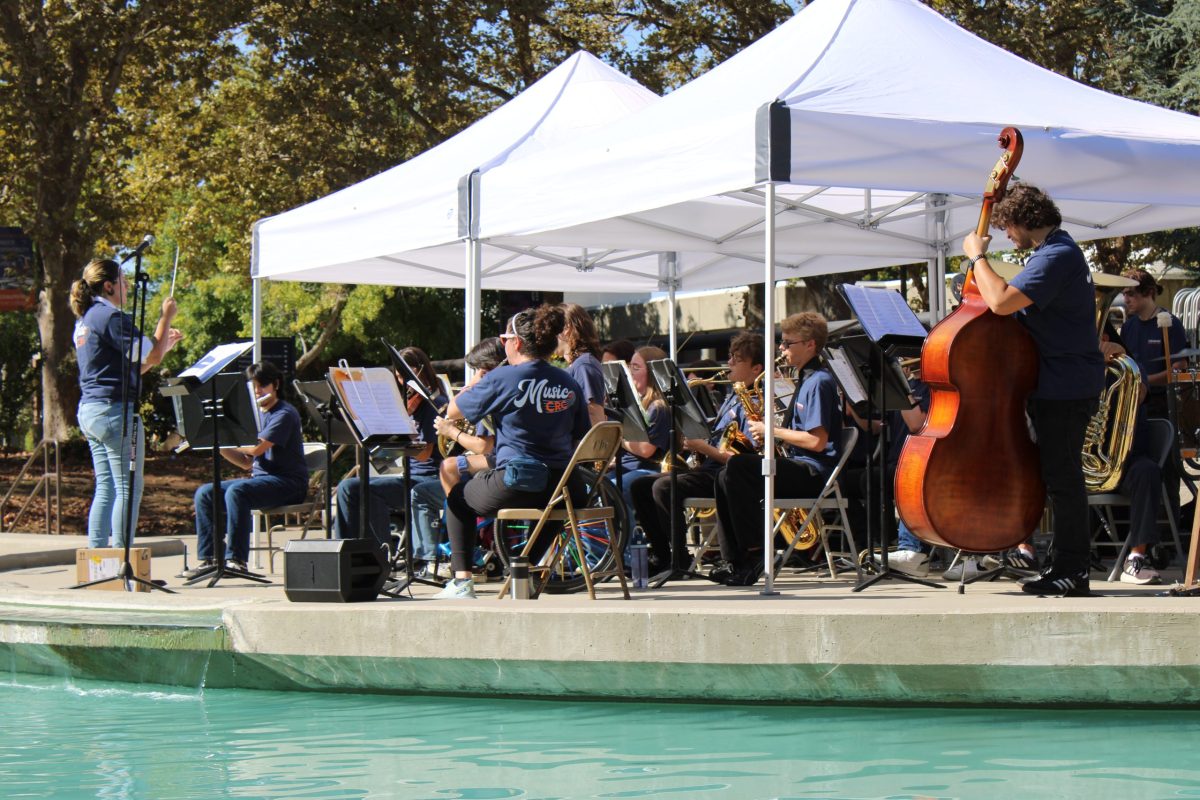 The concert band and orchestra performed four pieces on the fountain stage on Monday as a way to recruit new members. Professor Maxwell Kiesner, department chair of music, said teaching at Cosumnes River College allows him to stretch the limitations of what a band can do.