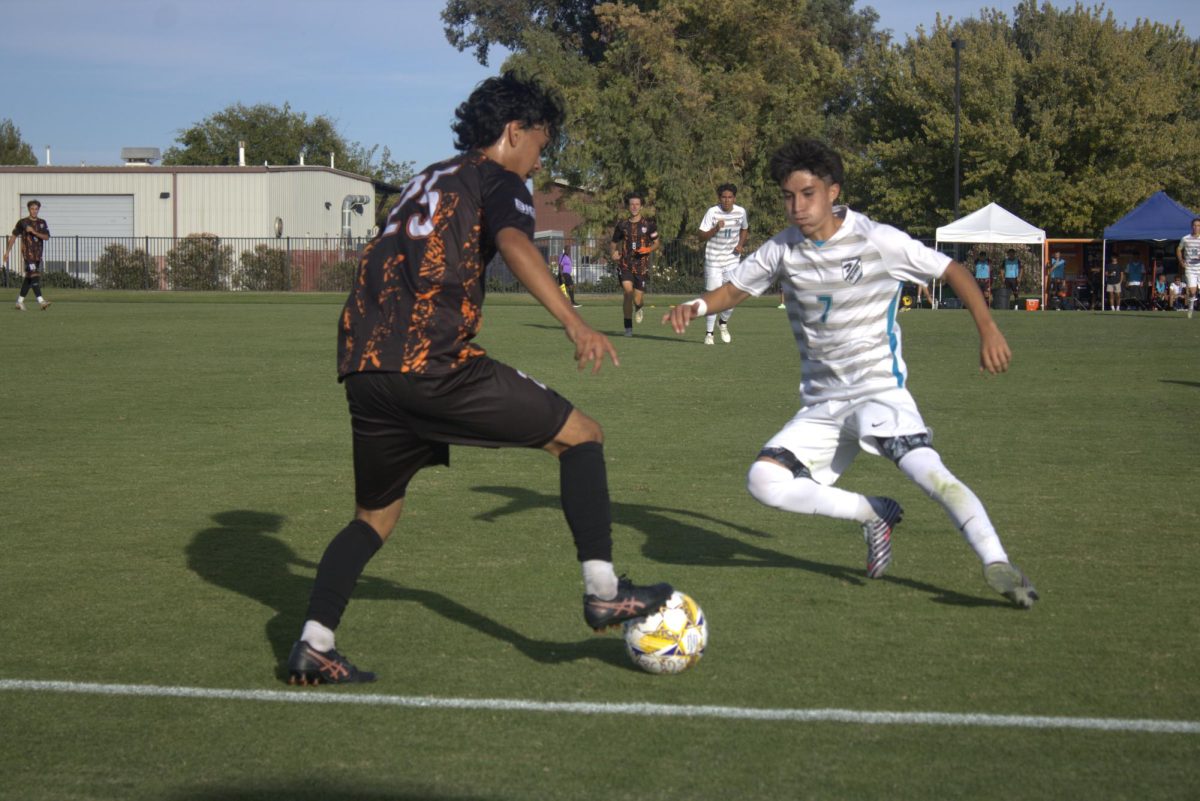 Hawks freshman defender Ezekiel Cruz (left) makes a play on the ball against a Folsom Lake College winger on Oct. 11 at home. The Hawks lost by one point with a final score of 3-2 and Cosumnes River College ranks No.2 overall in the Big 8 Conference. 