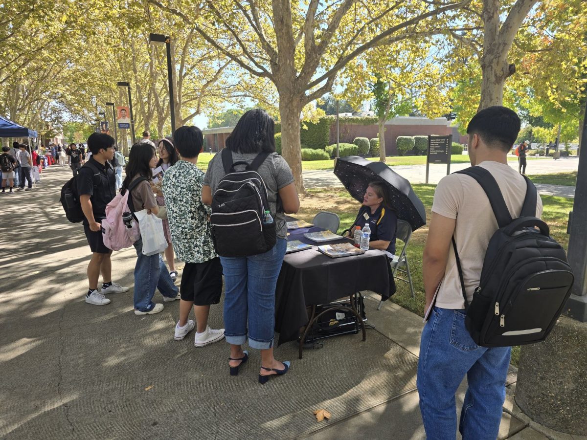 Cosumnes River College students talk with a transfer coordinator on Transfer Day on Sept. 24. Students can learn more about transfer opportunities at CRC's transfer center.