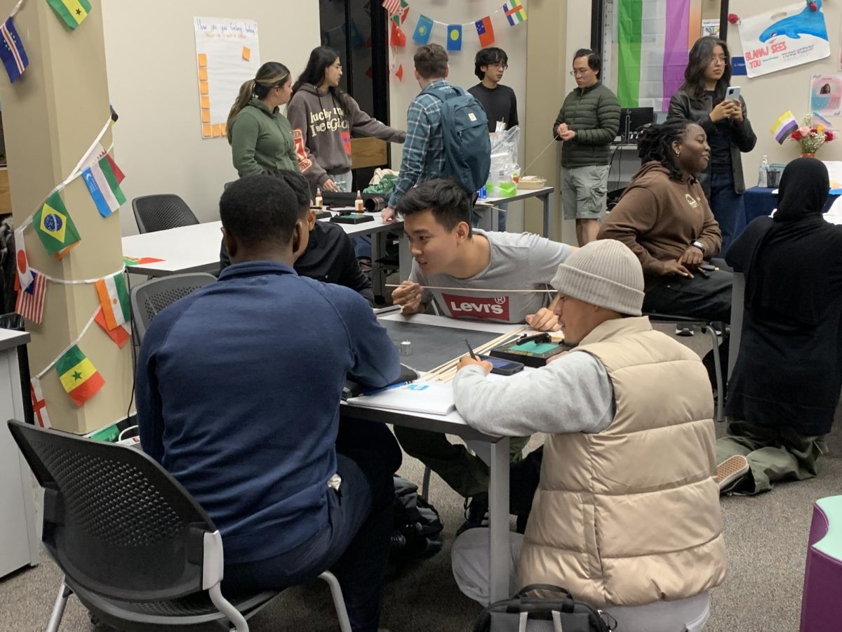 Long Bui, a 20-year-old civil engineer major, collaborates with the Architecture Student Association in the Bridge Building competition on Thursday. The Curiosity Engineering Club gives students the opportunity to learn more about engineering and participate in competitions. 