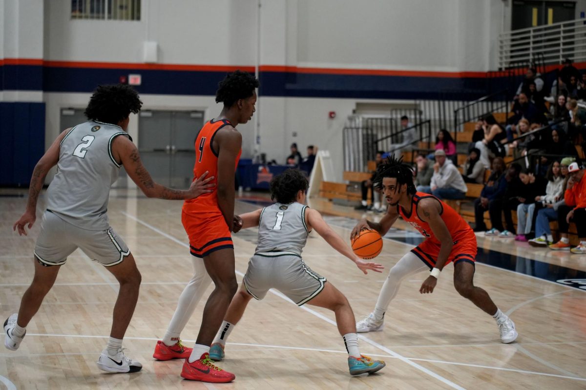 Sophomore guard Luca Davis looks to take a shot against Feather River College defenders at home on Nov. 26. The Hawks continue their win streak and improve to a 7-2 overall record after defeating College of the Siskiyous on Saturday.