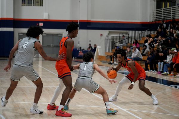 Sophomore guard Luca Davis looks to take a shot against Feather River College defenders at home on Nov. 26. The Hawks continue their win streak and improve to a 7-2 overall record after defeating College of the Siskiyous on Saturday.