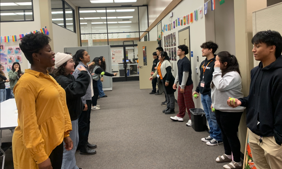 Students and attendees play pov pob, a Hmong ball tossing game, as an icebreaker for students to interact on Nov. 20 in the Center of Inclusion and Belonging. Hmong New Year is celebrated in late November or early December after the harvest season.