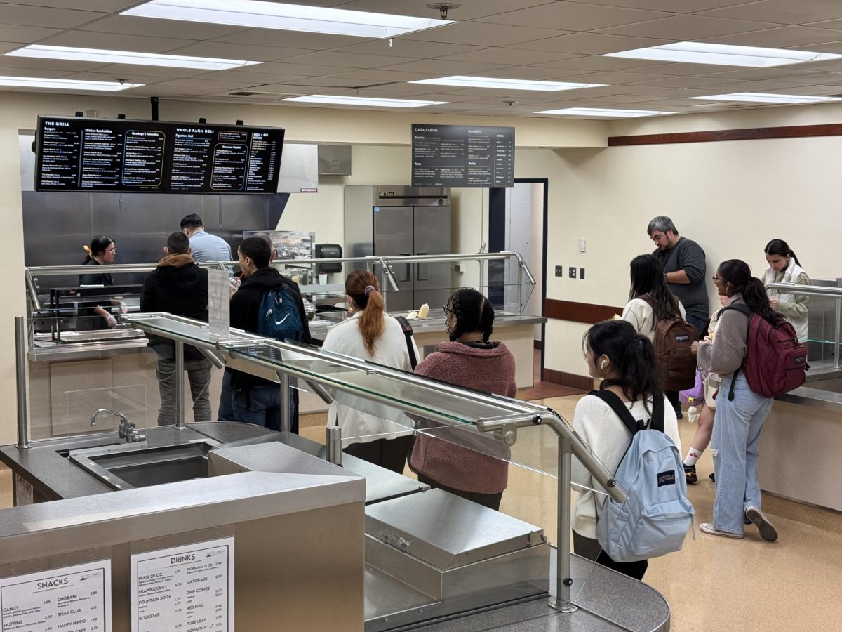 Students line up before the register to place their order inside the renovated campus cafeteria, called the Hawkeye Grill on Jan. 28. The menu features over 50 menus options, ranging from breakfast, deli sandwiches, burgers and vegan options.