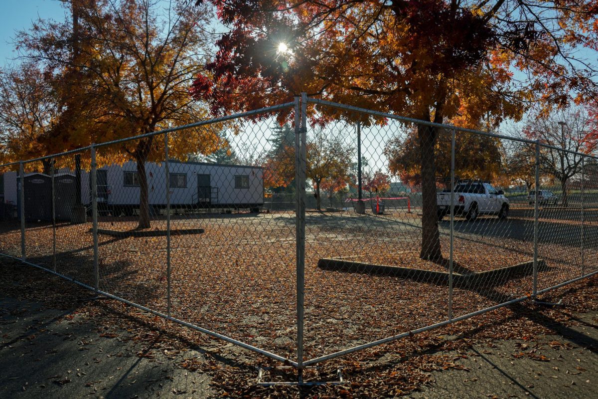 A portable construction office sits within an enclosed chainlink fence in Lot C on campus. Cosumnes River College is projected to complete construction of a student housing project in Lot C, housing at least 147 beds by the fall semester of 2028.