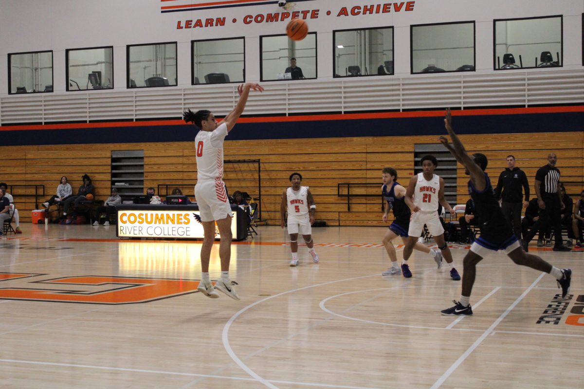 Freshman guard Mason Marsh attempts a 3-pointer during the first half of the game. The Hawks improve to a 14-9 overall record after their win against Folsom Lake College on Friday.