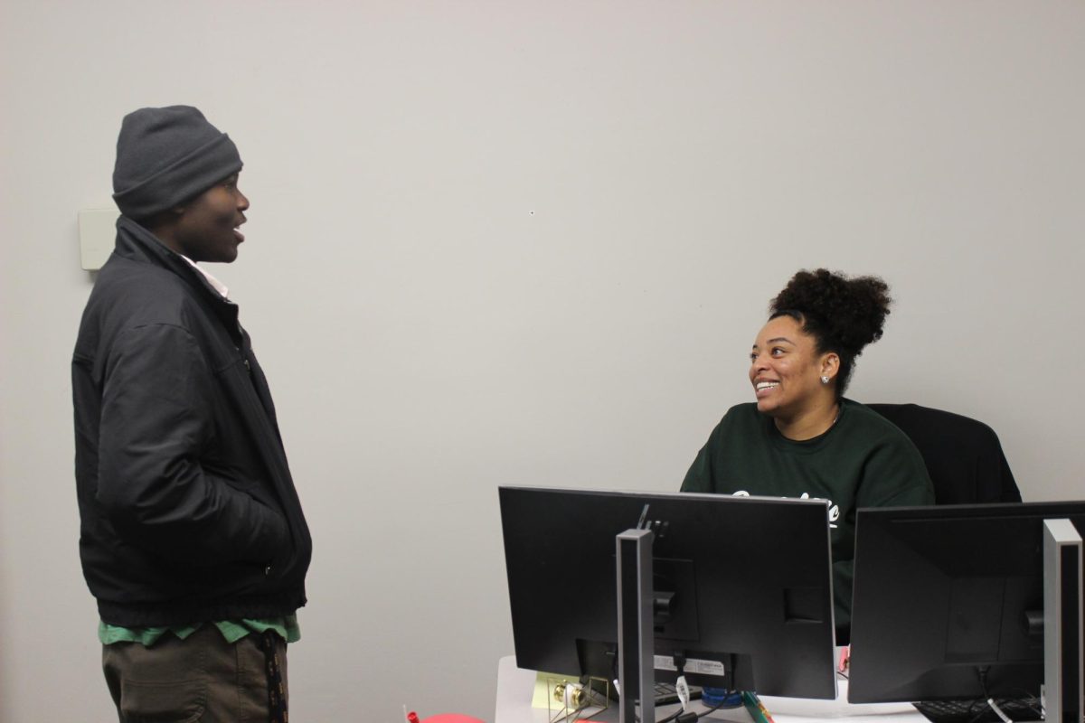 Black Student Support Specialist Brianna James chats with a student in her office, located in the Empowerment Center Library, Room L-125. James works in her position to nurture and mentor students