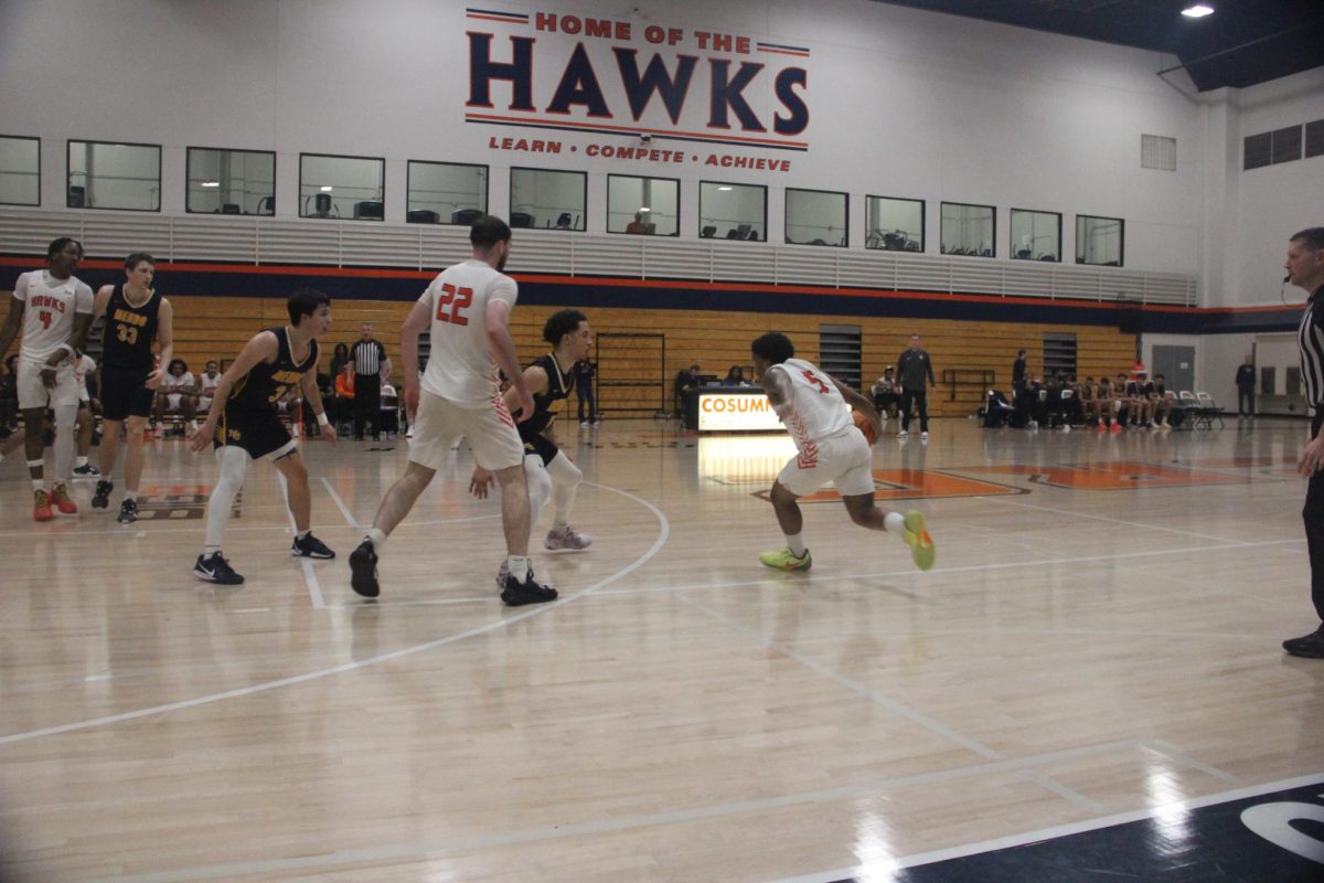 Sophomore guard Devon Haynes weaves his way through defenders early in the second half. The Hawks advance to play College of the Sequoias on Saturday.