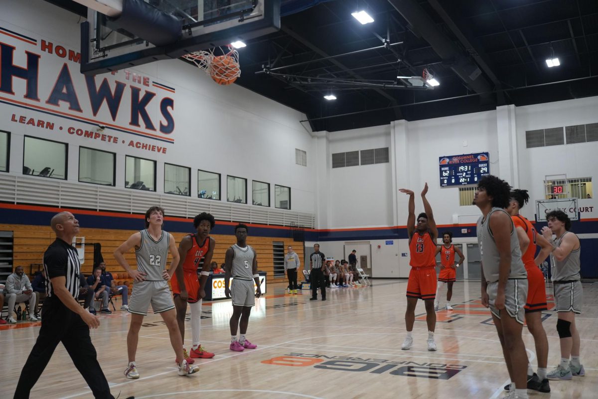 Sophomore forward Kole Simon shoots a free throw during the Hawks' matchup against Feather River on Nov. 26. The team finished the regular season on Thursday with a 18-9 overall record.