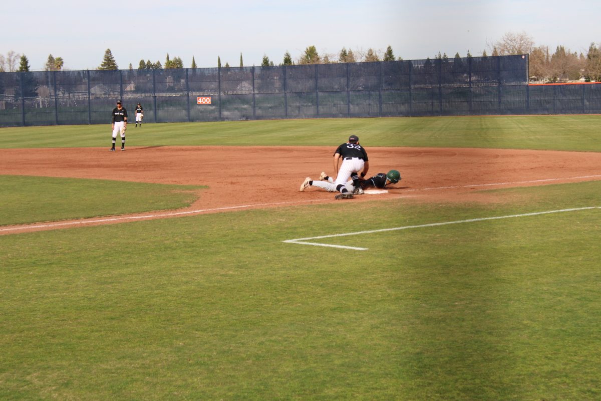 Freshman first baseman Guadalupe Gonzalez places a tag on the runner at first from a pick off from the pitcher. The Hawks won their first series of conference play against Diablo Valley College and now hold a 2-1 conference record.